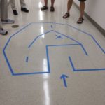 The maze taped on the floor was the first programming challenge which Dan finished first