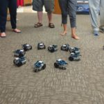Particpants arranged the robots in a circle and watched them all be controlled by the infrared signal from a Sony remote.