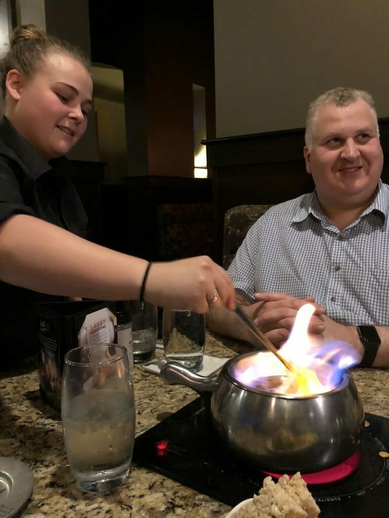 Dave, K1DLM watches as our waitress at the Melting Pot prepares the Fondue